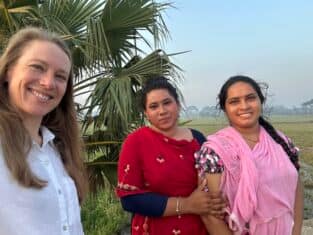 Sarah with two villagers